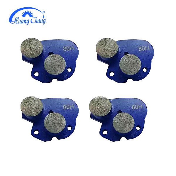 Double trapezoidal grinding head with diamond tips for concrete grinding